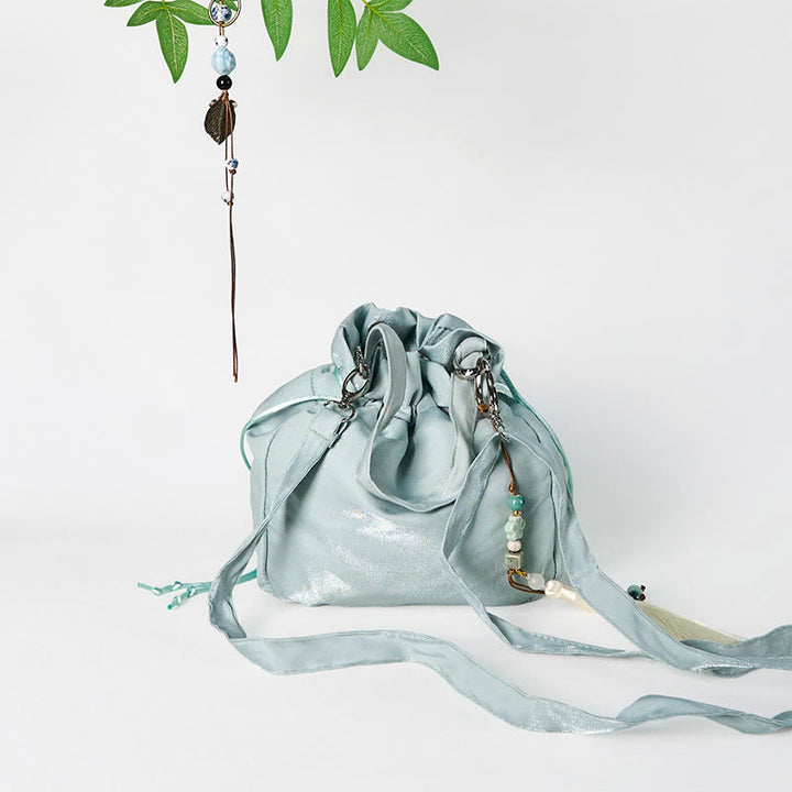 Bolso bandolera de lona con bordado de Buddha Stones, flores verdes y hojas.