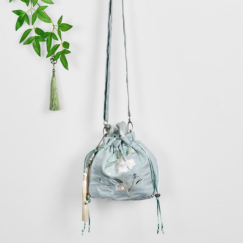 Bolso bandolera de lona con bordado de Buddha Stones, flores verdes y hojas.