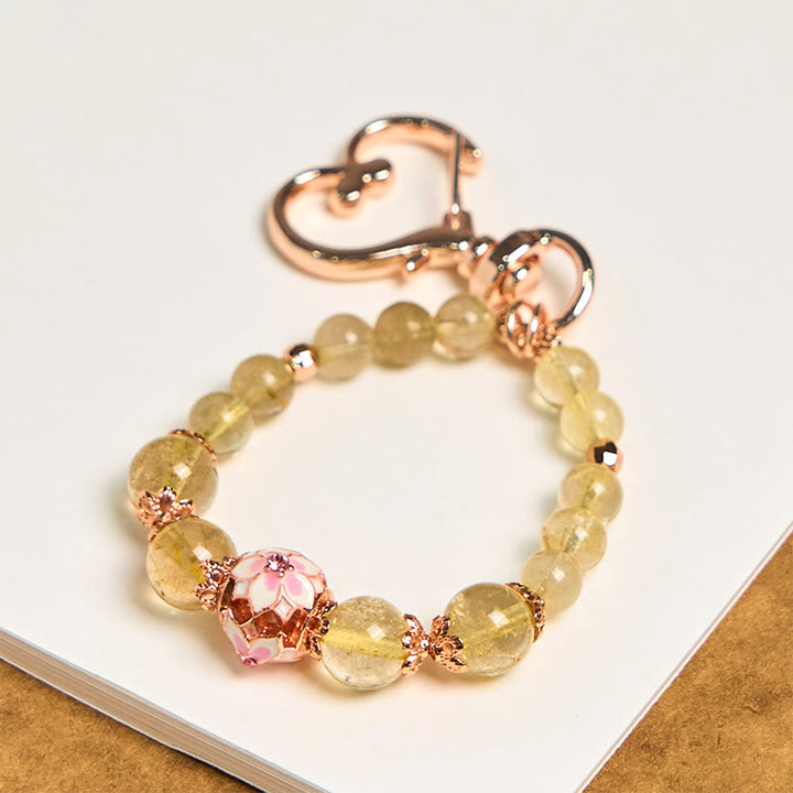 Llavero colgante de riqueza con Buddha Stones de cuarzo rutilado dorado