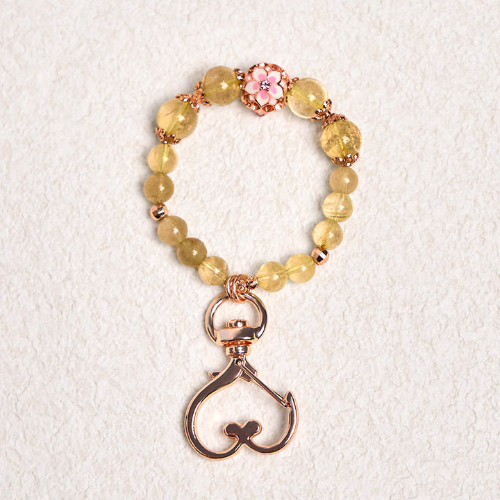 Llavero colgante de riqueza con Buddha Stones de cuarzo rutilado dorado