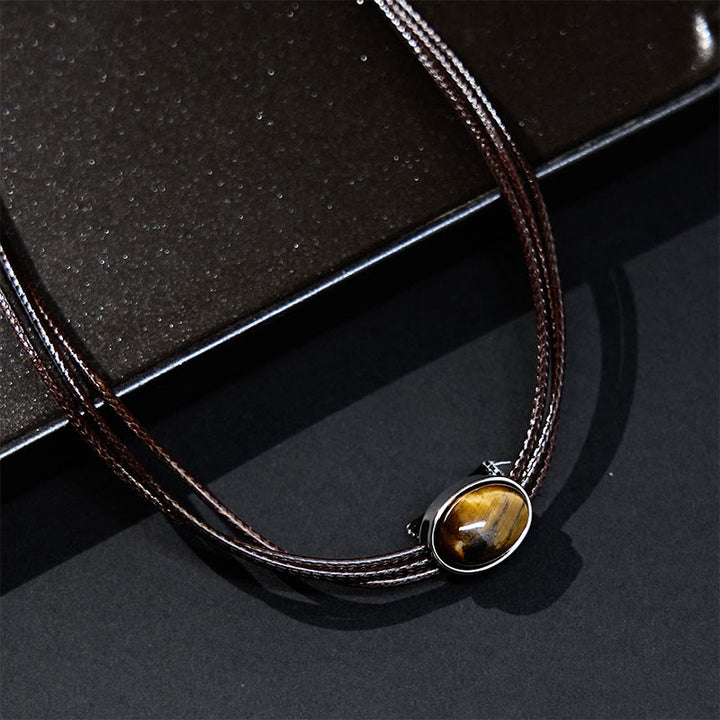 Collar con colgante de cuerda de cera con protección elíptica de ojo de tigre natural y Buddha Stones