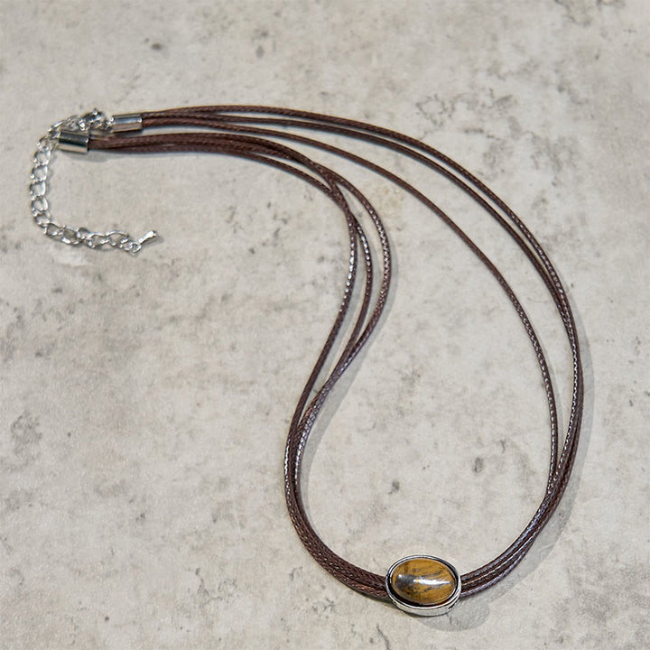 Collar con colgante de cuerda de cera con protección elíptica de ojo de tigre natural y Buddha Stones