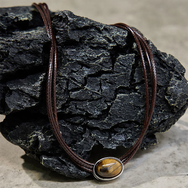 Collar con colgante de cuerda de cera con protección elíptica de ojo de tigre natural y Buddha Stones
