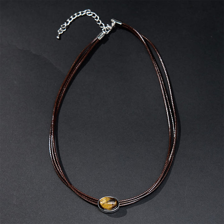 Collar con colgante de cuerda de cera con protección elíptica de ojo de tigre natural y Buddha Stones