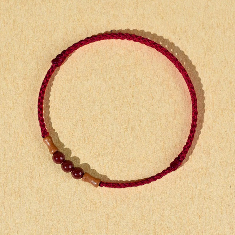 Pulsera de hilo bendecido de madera de melocotón con cuentas de cinabrio y Buddha Stones