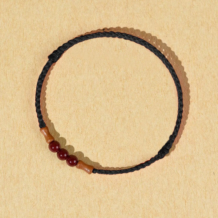 Pulsera de hilo bendecido de madera de melocotón con cuentas de cinabrio y Buddha Stones