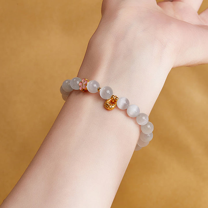 Pulsera con Buddha Stones en plata de ley 925 con flor de melocotón natural y ojo de gato blanco