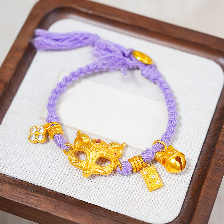 Pulsera de la suerte tejida con hilo morado, con dije de campana de zorro de latón chapado en oro de 24k y Buddha Stones. - image 0