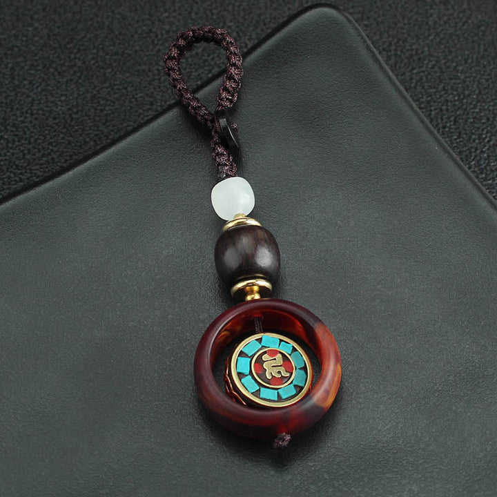 Llavero giratorio con Buddha Stones, madera de ébano, trébol de cuatro hojas en sánscrito, ojo de Buda y paz. - image 2