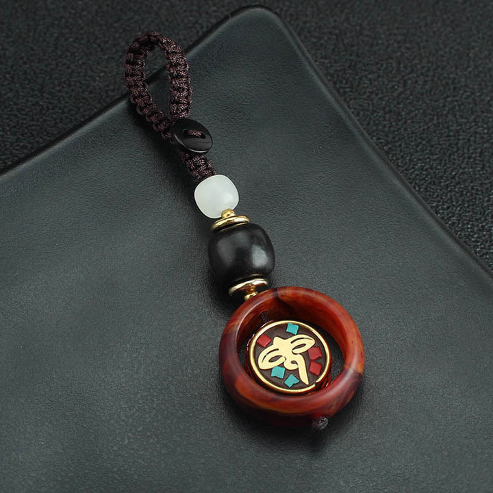 Llavero giratorio con Buddha Stones, madera de ébano, trébol de cuatro hojas en sánscrito, ojo de Buda y paz. - image 7