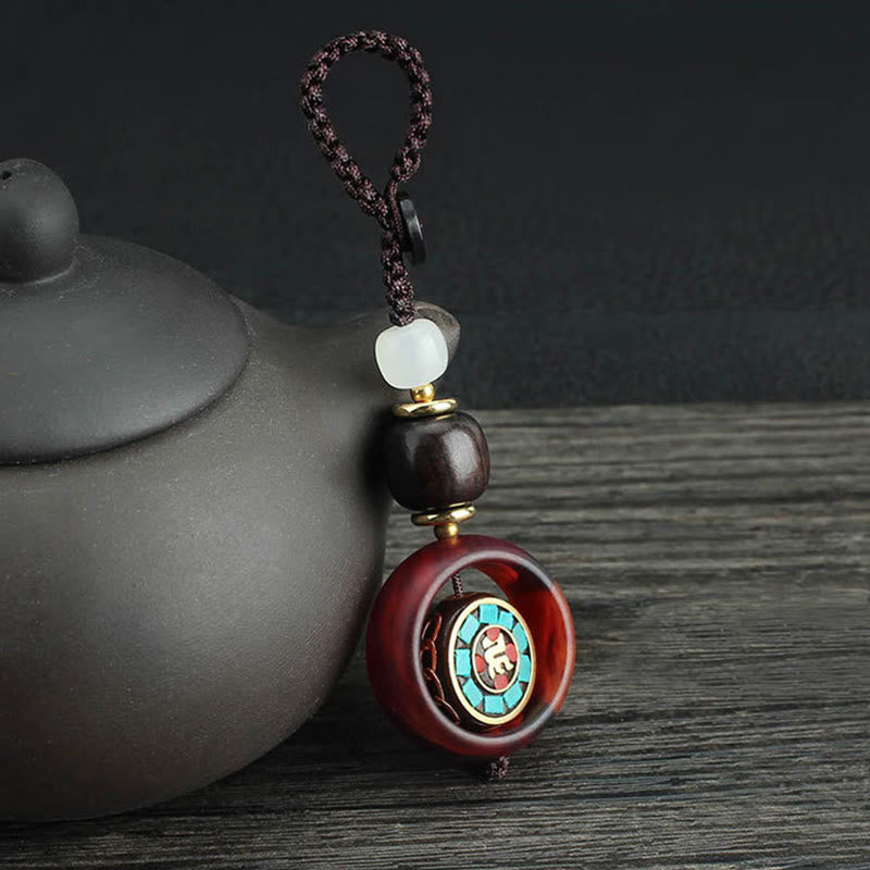 Llavero giratorio con Buddha Stones, madera de ébano, trébol de cuatro hojas en sánscrito, ojo de Buda y paz. - Patrón sánscrito - image 0