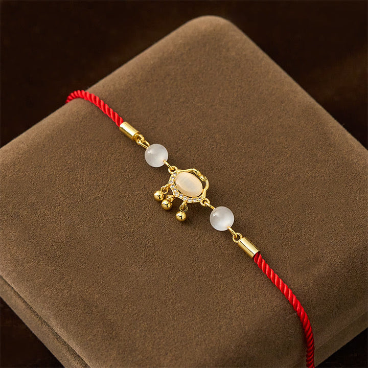 Pulsera protectora chapada en oro y cobre con abalorio de ojo de gato y Buddha Stones - image 2
