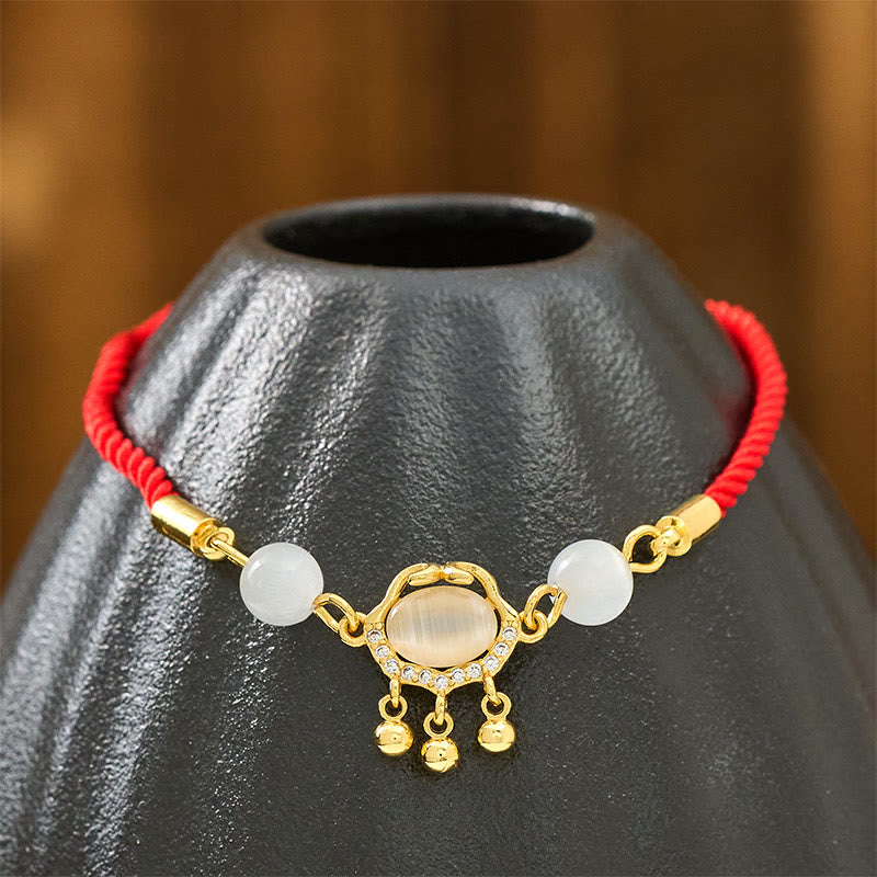 Pulsera protectora chapada en oro y cobre con abalorio de ojo de gato y Buddha Stones - image 4