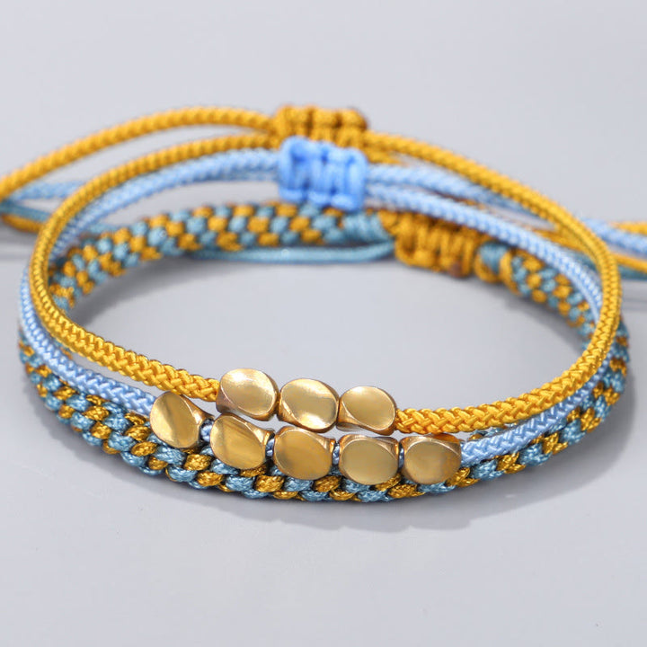 Buddha Stones Pulsera curativa de 3 piezas con cuentas de cobre dorado y hilo azul y amarillo. - Cuerda (circunferencia de la muñeca: 16-26 cm) - image 0