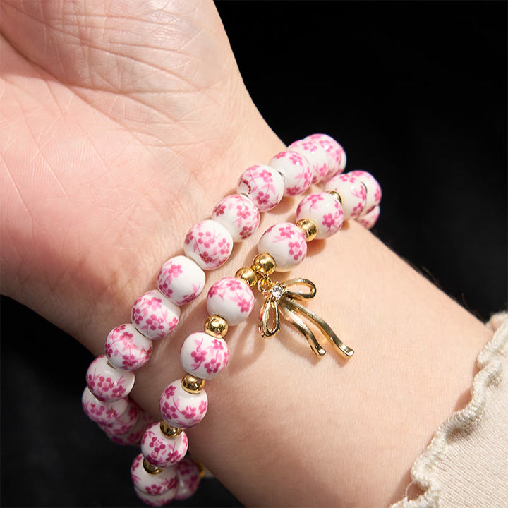 Buddha Stones Pulsera de cuentas de porcelana azul, blanca y rosa con lazo y palabra de honor - image 9