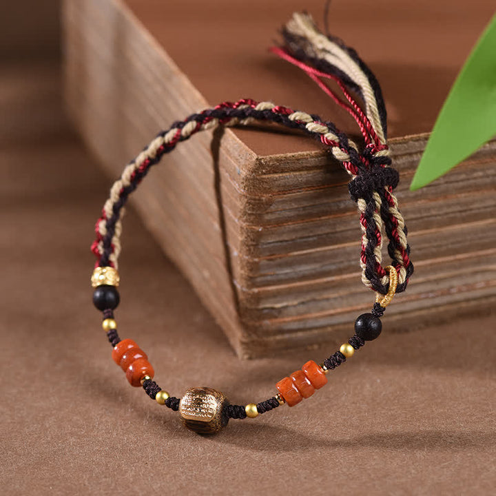Buddha Stones Pulsera trenzada con borla de sándalo rojo tejida a mano con símbolo de bendición - image 1