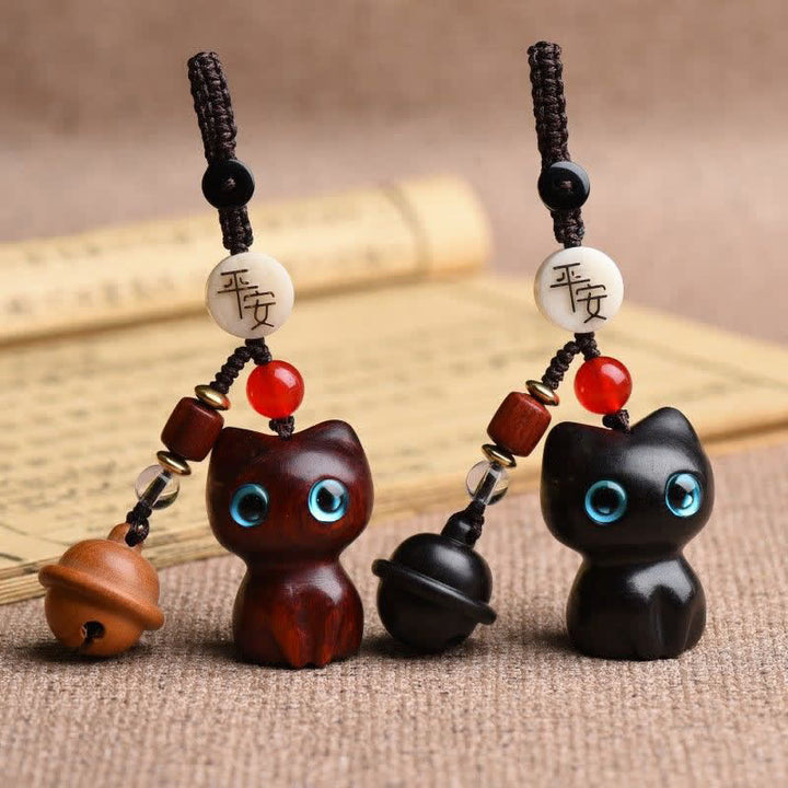 Buddha Stones Llaveros protectores con cascabel para gatos, tallados a mano en madera de ébano y sándalo rojo. - image 0