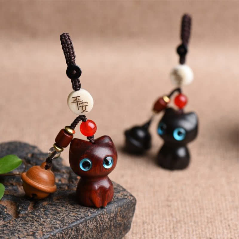 Buddha Stones Llaveros protectores con cascabel para gatos, tallados a mano en madera de ébano y sándalo rojo. - image 1