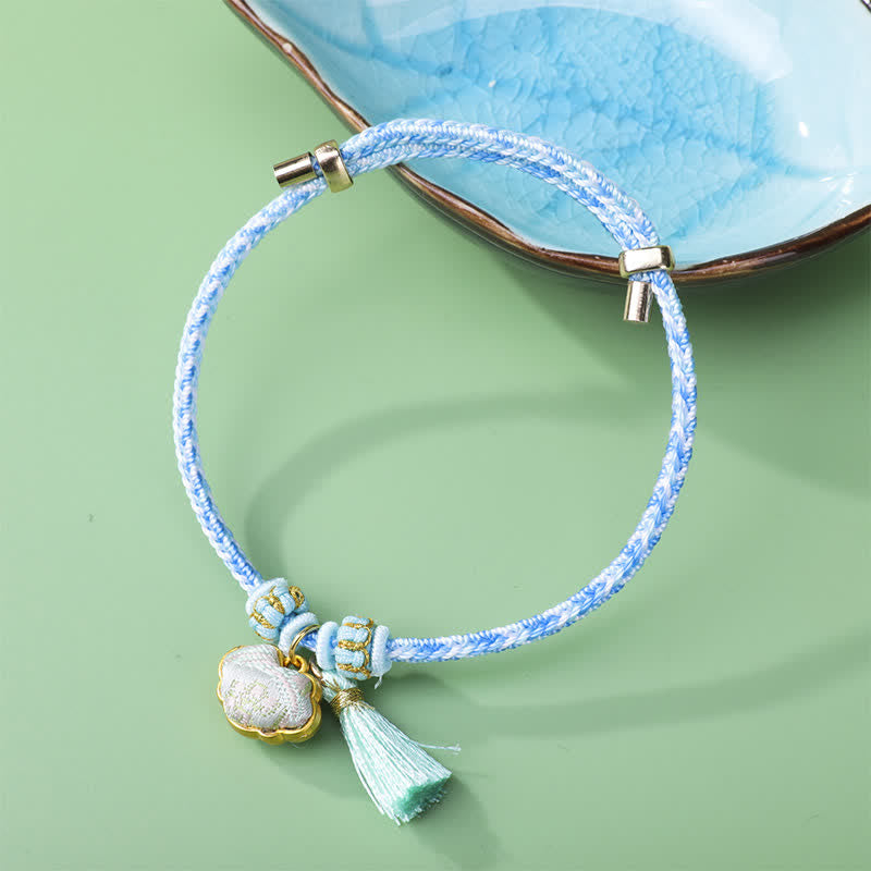 Buddha Stones Pulsera de la suerte con borla de cetro Ruyi, cordón trenzado de cinco colores y brocado. - Azul claro (mismo tono de color, el estampado varía) - image 1