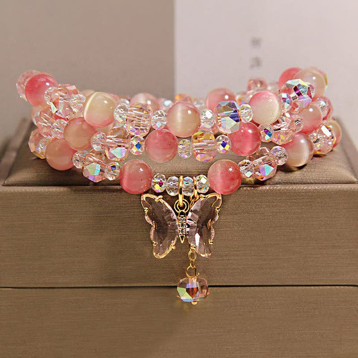 Buddha Stones Pulsera facetada triple con mariposa ojo de gato color melocotón - image 1