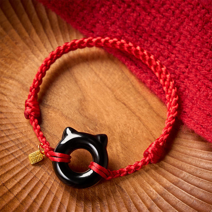 Buddha Stones Pulsera trenzada de protección con hebilla de paz y diseño de gato de obsidiana negra, personaje Fu, con cordón rojo. - image 1