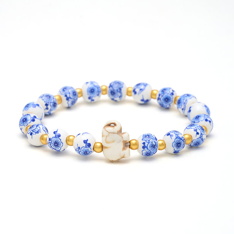 Buddha Stones Pulsera redonda de cuentas florales con forma de elefante de porcelana blanca - Elefante (FUERZA ♥ SABIDURÍA) - image 0
