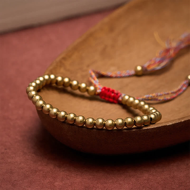 Buddha Stones Pulsera de equilibrio con cuentas de cobre y cordón rojo - image 1