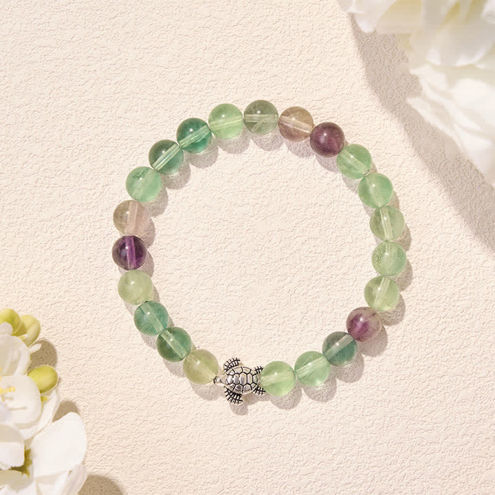 Buddha Stones Pulsera de cuentas de fluorita multicolor con forma de tortuga, que ofrece claridad y protección. - image 2