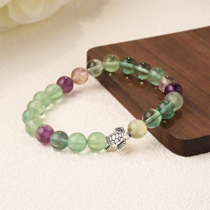 Buddha Stones Pulsera de cuentas de fluorita multicolor con forma de tortuga, que ofrece claridad y protección. - image 3