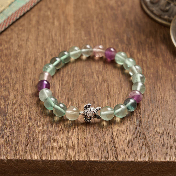 Buddha Stones Pulsera de cuentas de fluorita multicolor con forma de tortuga, que ofrece claridad y protección. - image 4