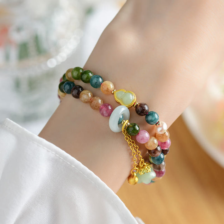 Pulsera con dije de lirio de los valles de doble envoltura de sabiduría de calabaza de turmalina multicolor con Buddha Stones