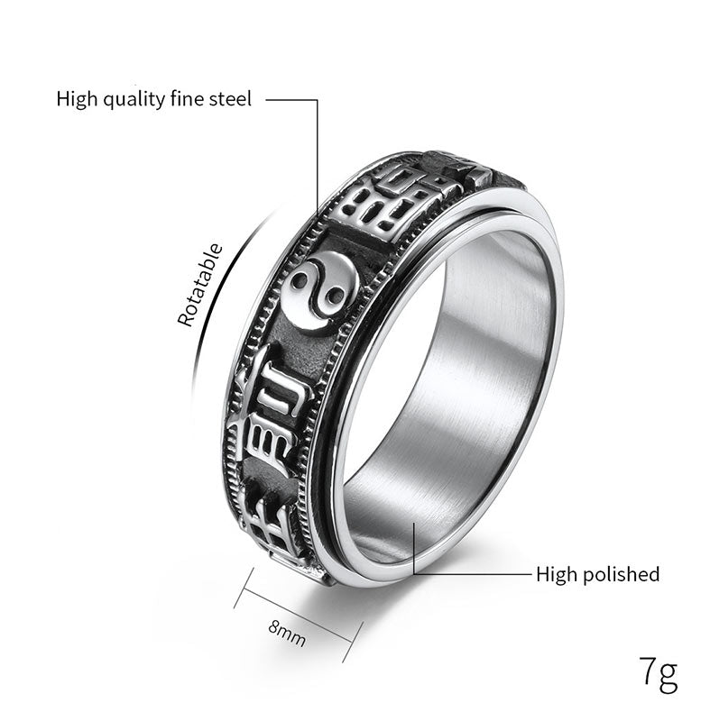 Anillo giratorio de acero titanio con letras en equilibrio y calma