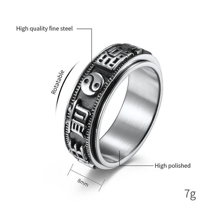 Anillo giratorio de acero titanio con letras en equilibrio y calma