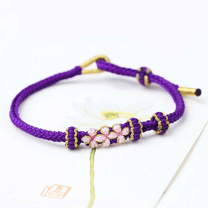 Pulsera de cuerda trenzada de ocho hebras de la suerte con tres flores de melocotón hechas a mano con Buddha Stones