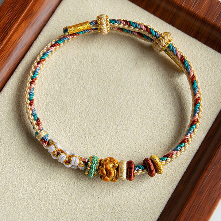 Pulsera de hilo trenzado con diseño de flor de melocotón de color Dunhuang hecha a mano con Buddha Stones