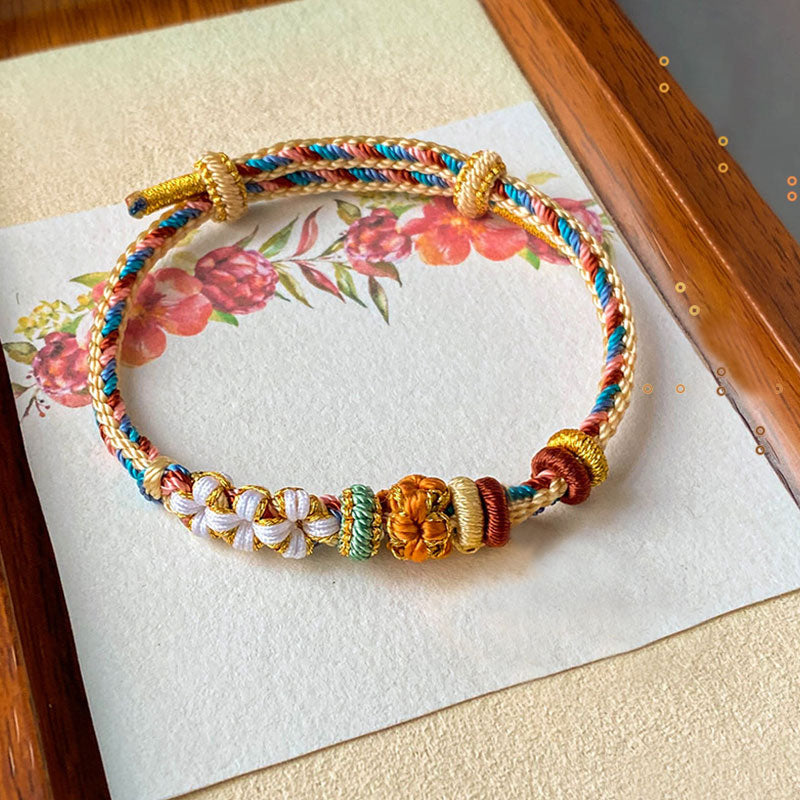 Pulsera de hilo trenzado con diseño de flor de melocotón de color Dunhuang hecha a mano con Buddha Stones