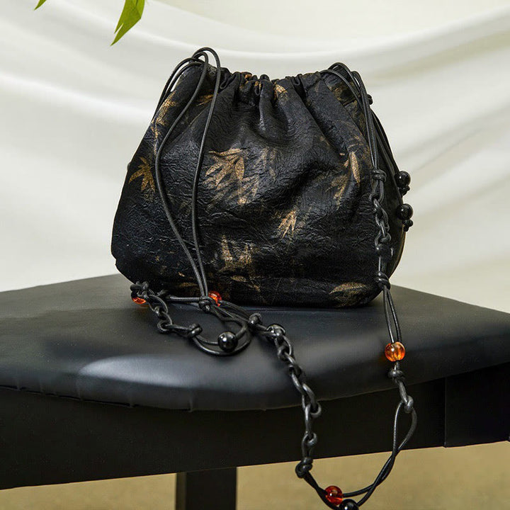 Bolso bandolera de acetato con estampado de hojas de bambú amarillo con Buddha Stones