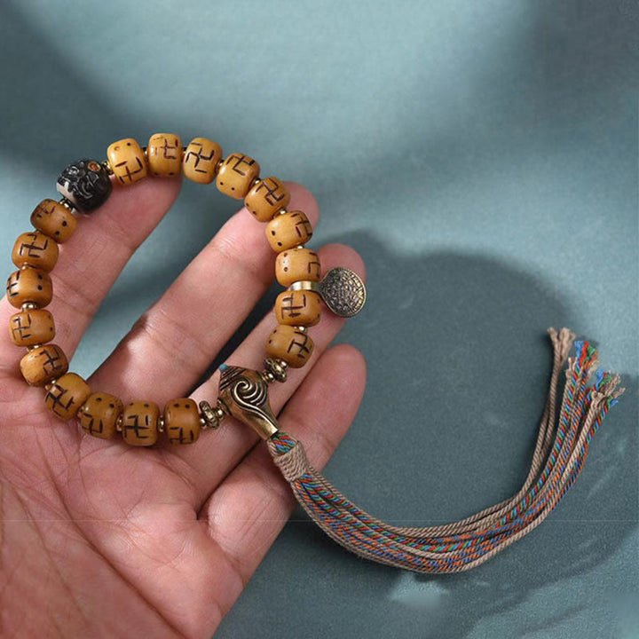 Buddha Stones, hueso de camello tibetano Natural, esvástica, cuentas Dzi, amuleto de Buda Shankha, Kirtimukha, pulsera con borla de protección de la suerte
