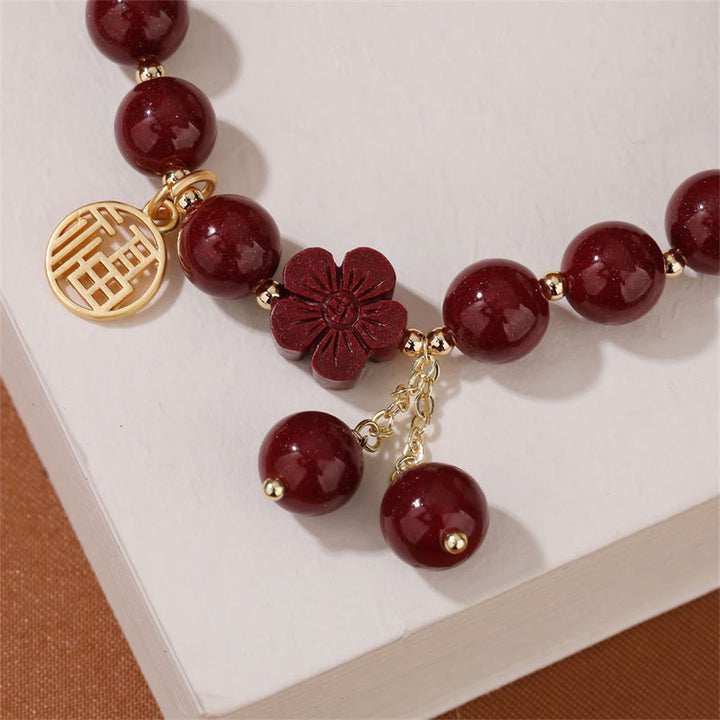 Pulsera de bendición de flor de cerezo con personaje de cinabrio de Buddha Stones