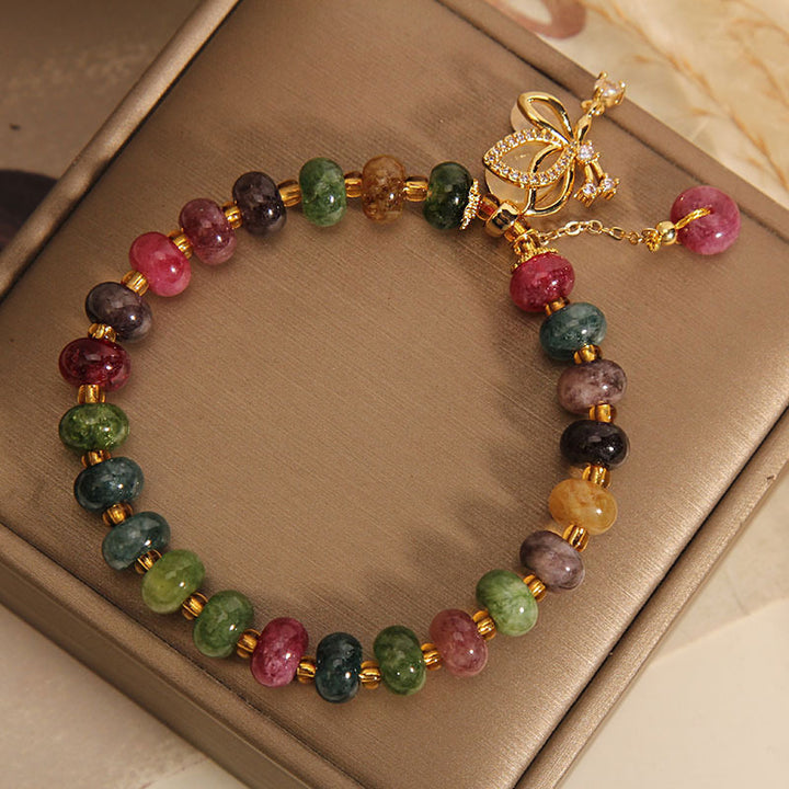 Pulsera de sabiduría con dije de mariposa y turmalina colorida con Buddha Stones