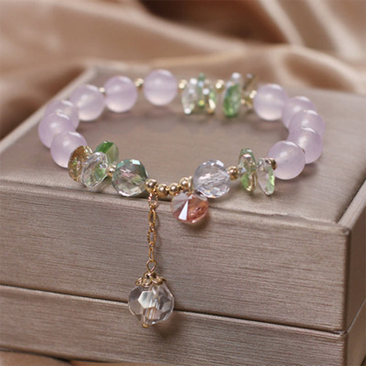 Pulsera con dije de paz y cristal rosa con ojo de gato y Buddha Stones