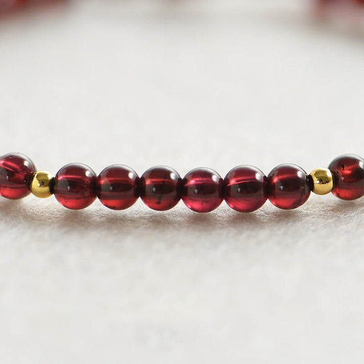 Pulsera de estabilidad con cuentas doradas y granate natural con Buddha Stones