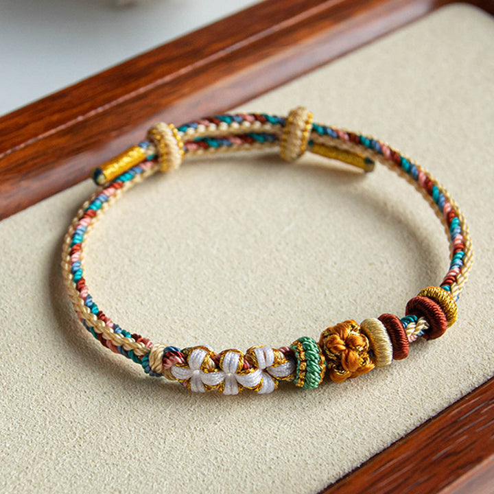 Pulsera de hilo trenzado con diseño de flor de melocotón de color Dunhuang hecha a mano con Buddha Stones