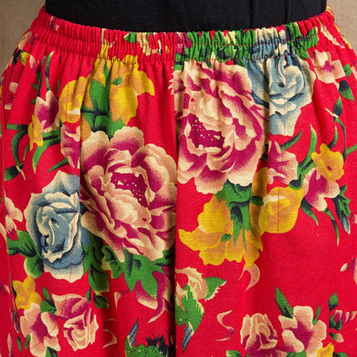 Pantalones bombachos con estampado de flores rojas y verdes de estilo étnico con Buddha Stones y bolsillos