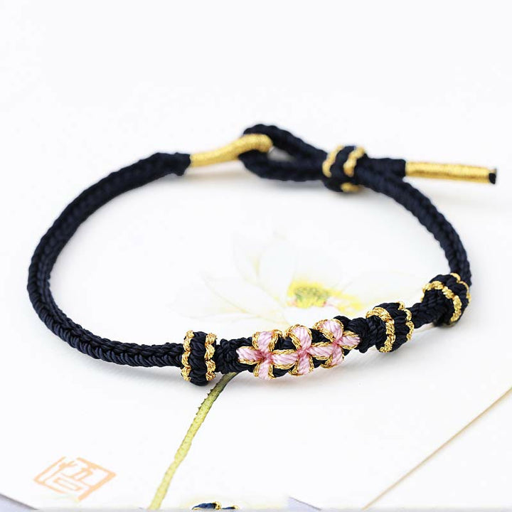 Pulsera de cuerda trenzada de ocho hebras de la suerte con tres flores de melocotón hechas a mano con Buddha Stones