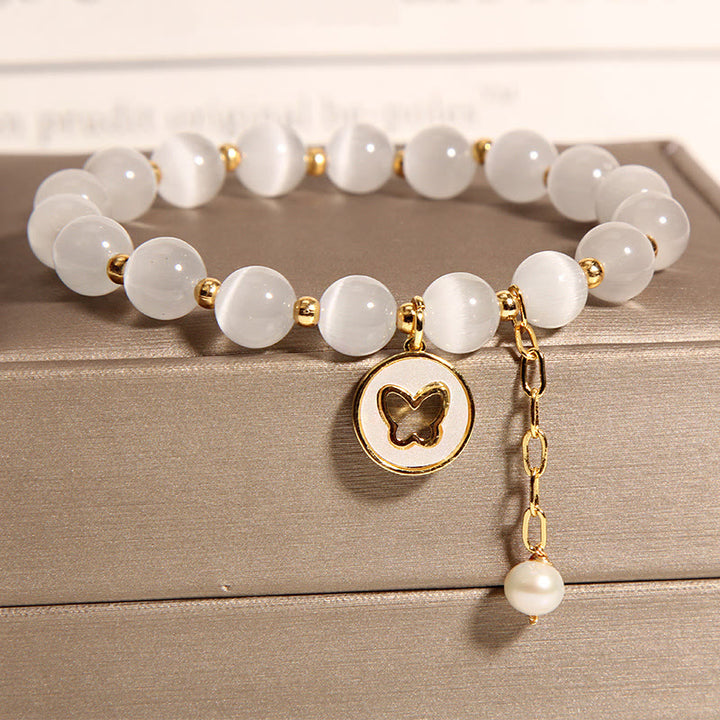 Pulsera de amor con dije de mariposa y ojo de gato con Buddha Stones