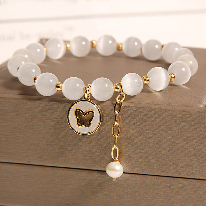 Pulsera de amor con dije de mariposa y ojo de gato con Buddha Stones