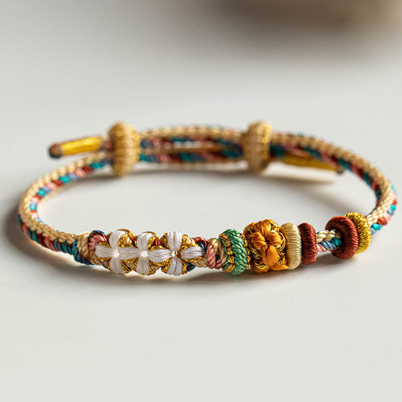 Pulsera de hilo trenzado con diseño de flor de melocotón de color Dunhuang hecha a mano con Buddha Stones