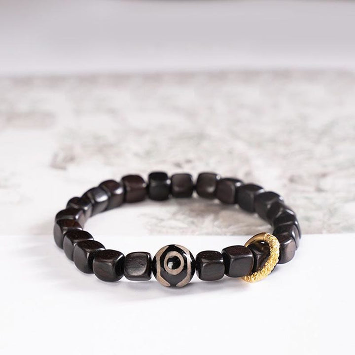Pulsera de equilibrio de cuentas Dzi de madera de ébano tibetano con Buddha Stones