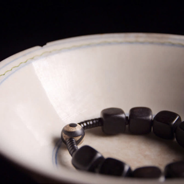 Pulsera resistente con cuentas Dzi de madera de ébano tibetano con Buddha Stones